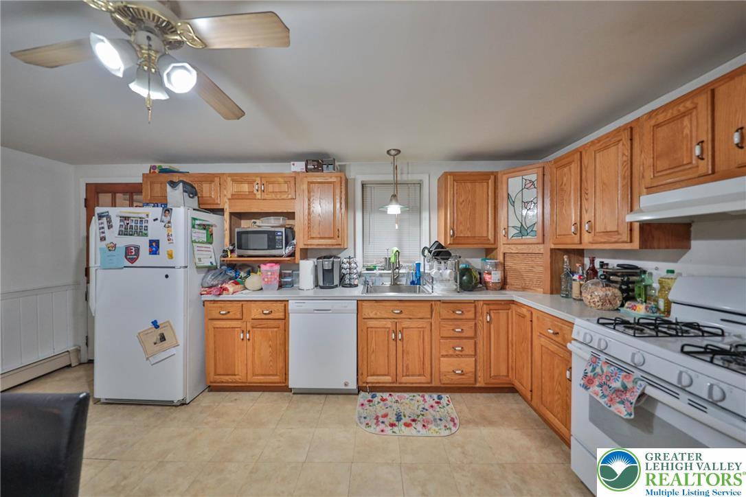 1770 Weilers Road Lower Macungie Township, PA 18011 - Photo 23 of 29 a kitchen with stainless steel appliances granite countertop a sink cabinets and window
