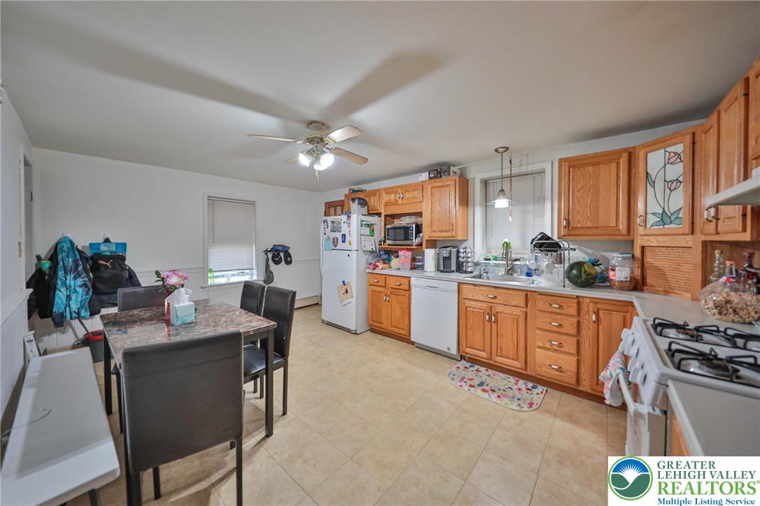 1770 Weilers Road Lower Macungie Township, PA 18011 - Photo 24 of 29 a kitchen with stainless steel appliances granite countertop a stove a sink dishwasher a dining table and chairs with wooden floor