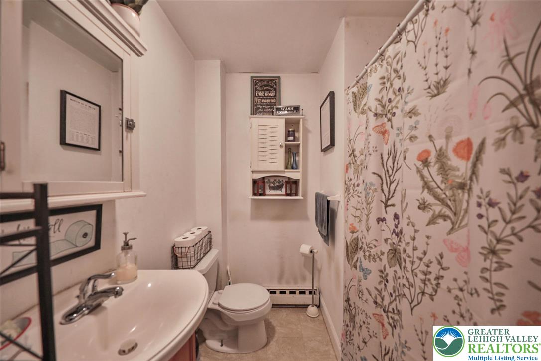 1770 Weilers Road Lower Macungie Township, PA 18011 - Photo 6 of 29 a bathroom with a toilet sink and mirror