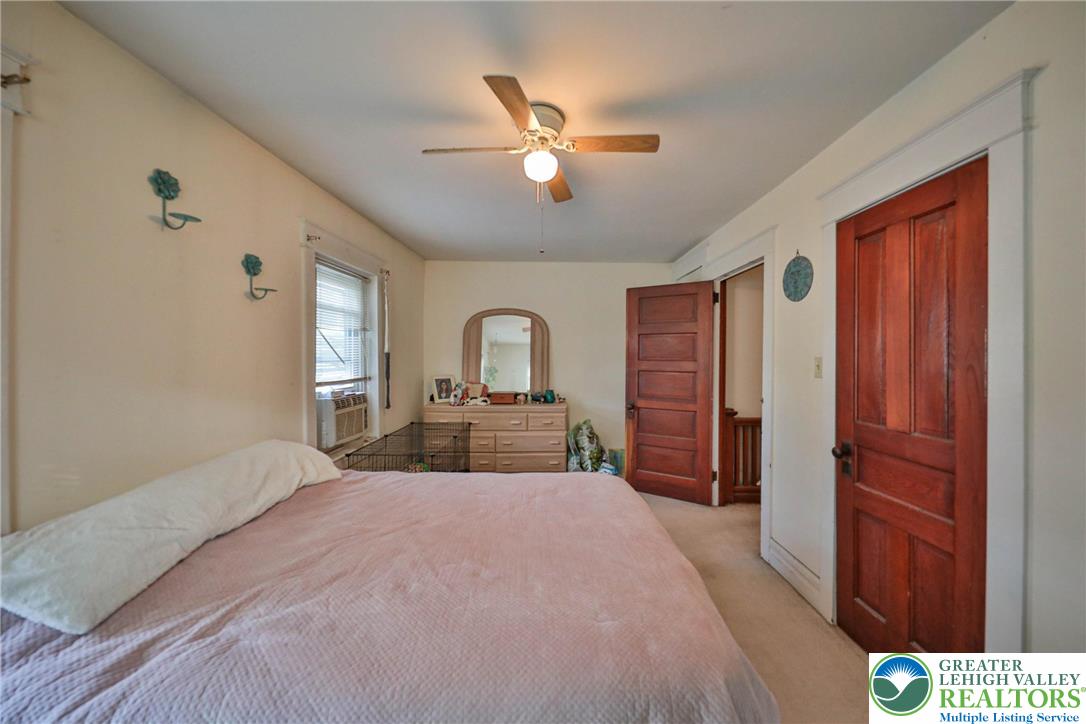 1770 Weilers Road Lower Macungie Township, PA 18011 - Photo 8 of 29 a bedroom with a large bed and a chandelier