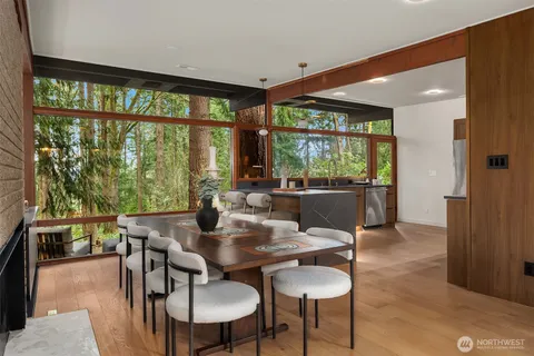 a dining room with furniture a chandelier and wooden floor