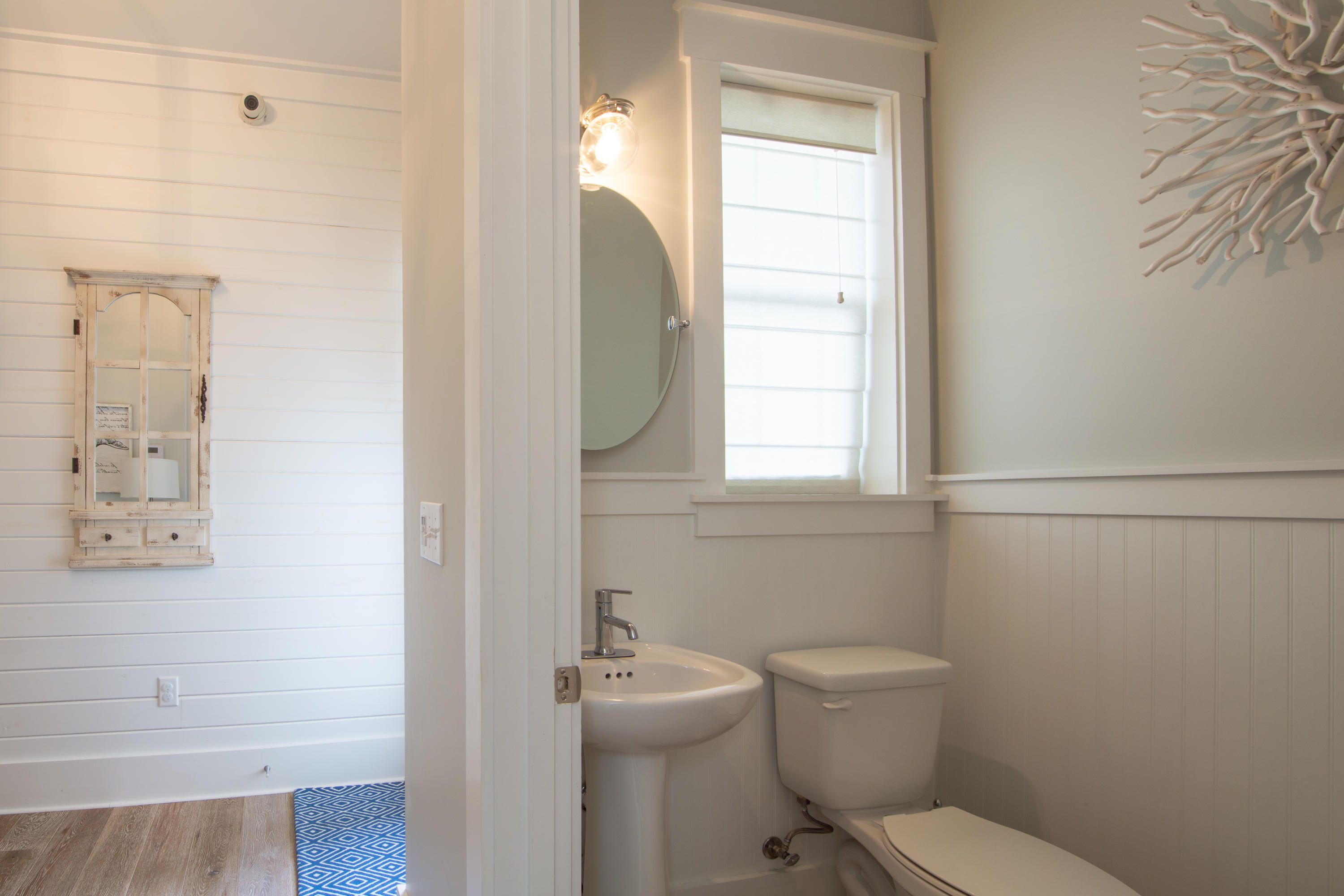 158 East Blue Crab Loop Inlet Beach, FL 32461 - Photo 11 of 43 a bathroom with a toilet a sink and mirror
