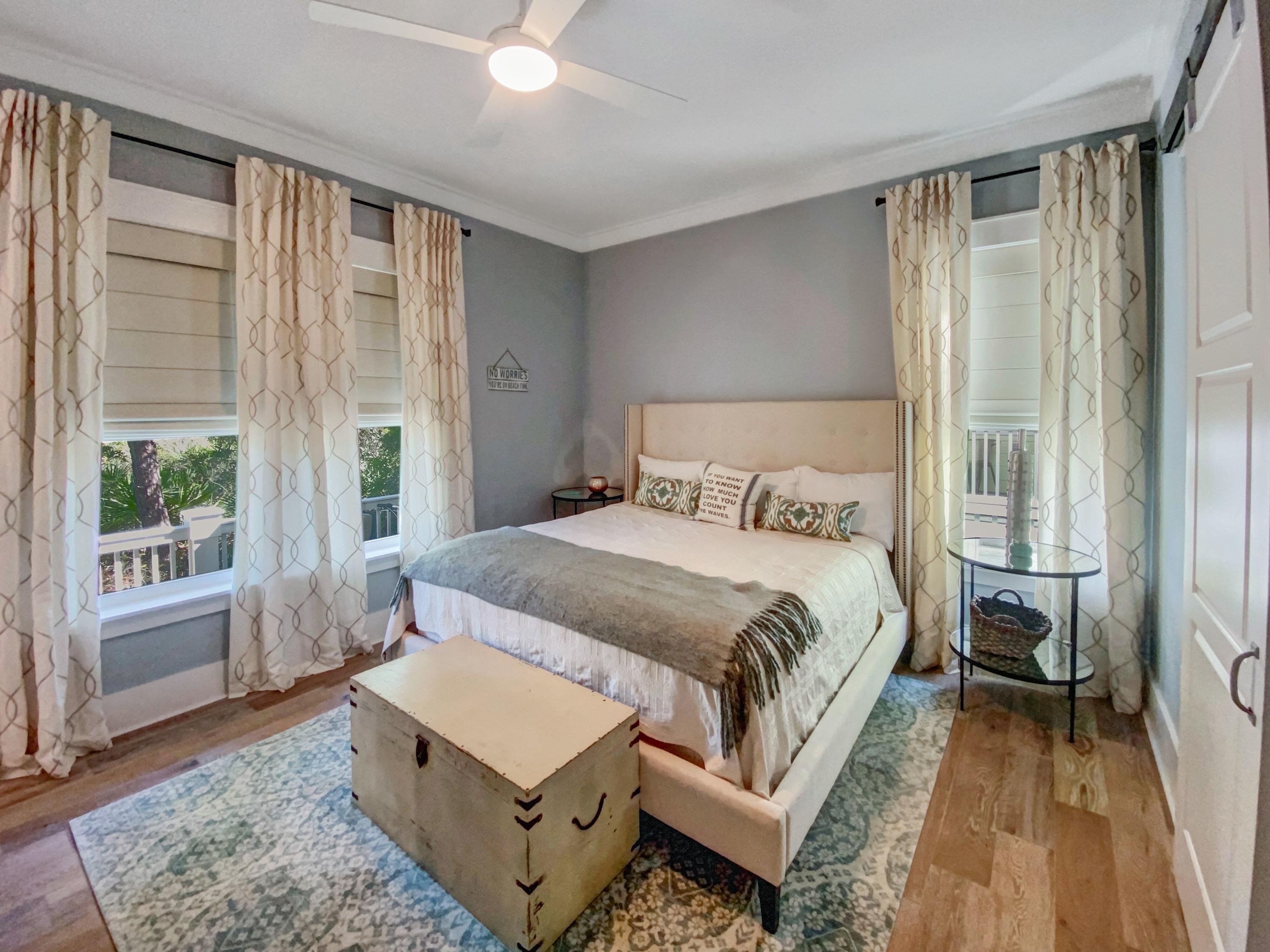 158 East Blue Crab Loop Inlet Beach, FL 32461 - Photo 13 of 43 a bedroom with a bed lamp and a large window