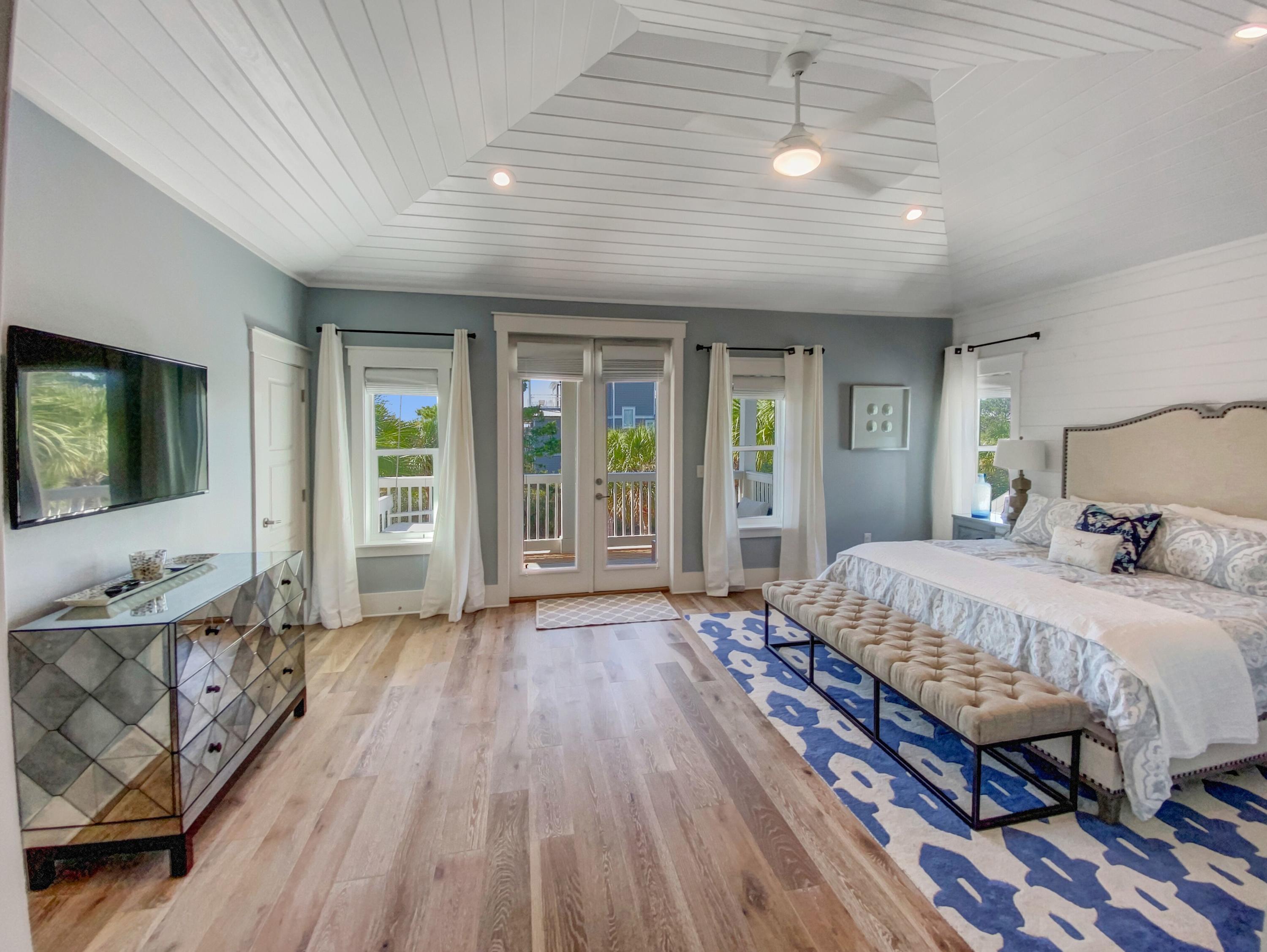 158 East Blue Crab Loop Inlet Beach, FL 32461 - Photo 28 of 43 a spacious bedroom with a bed and wooden floor