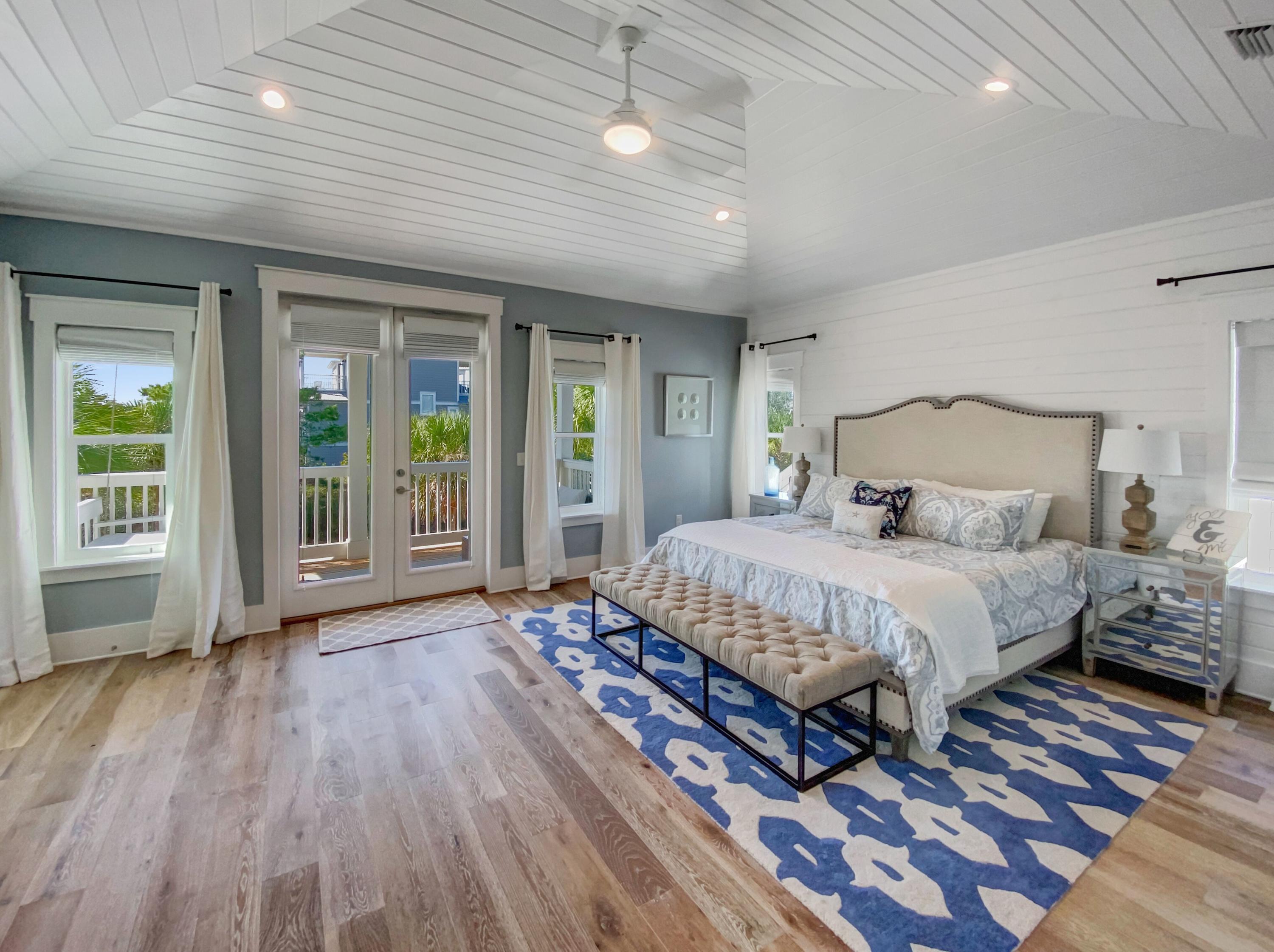 158 East Blue Crab Loop Inlet Beach, FL 32461 - Photo 32 of 43 a spacious bedroom with a large bed and a large window