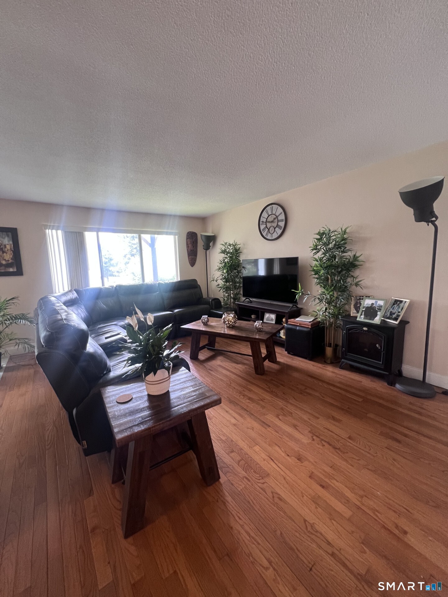 93 Kent Court, Unit 93 Meriden, CT 06450 - Photo 19 of 27 a living room with furniture kitchen view and a wooden floor