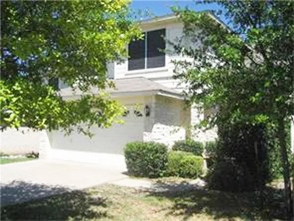 a front view of a house with a yard garage and outdoor seating