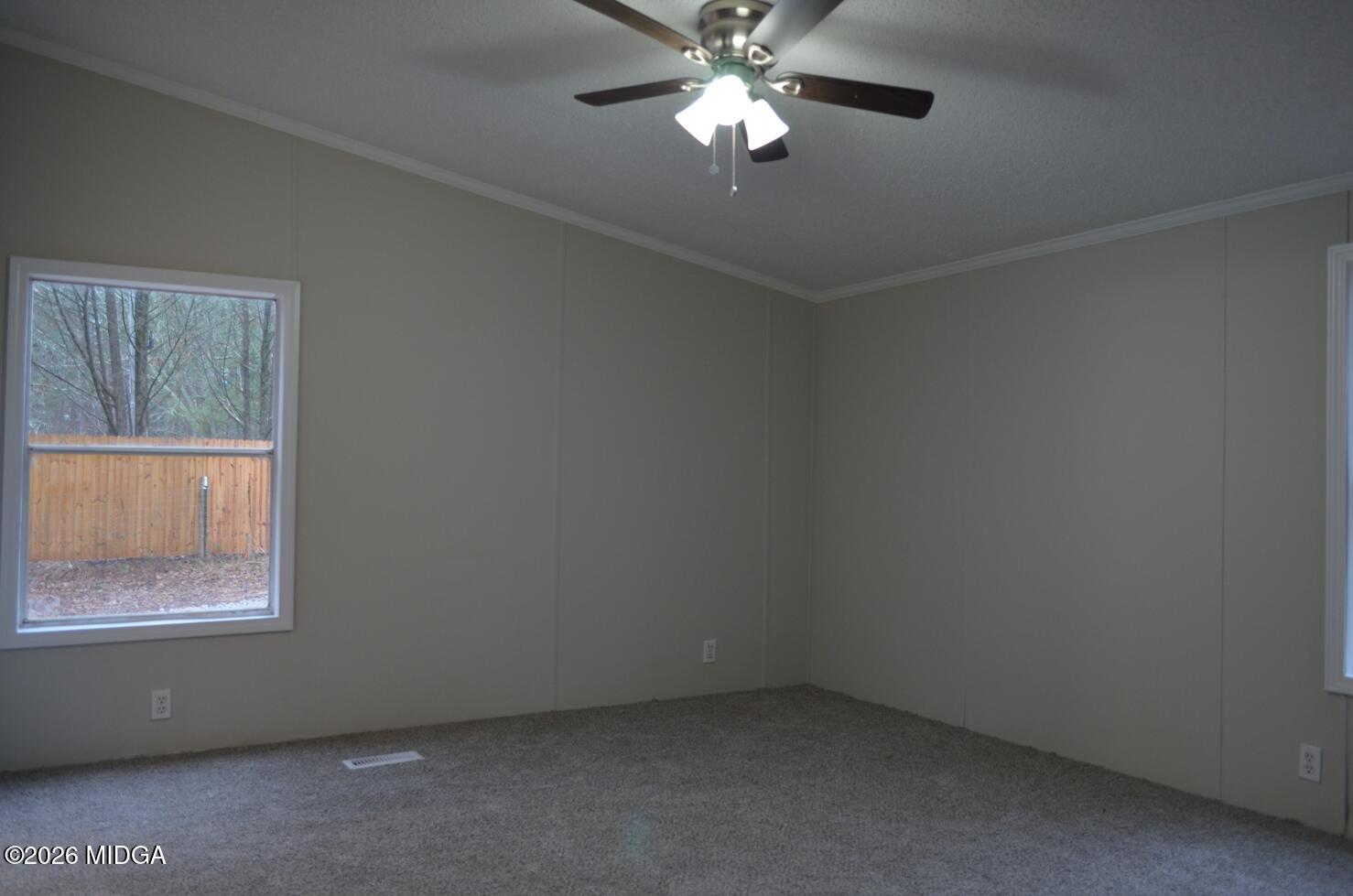 1048 Lee King Road Forsyth, GA 31029 - Photo 8 of 19 an empty room with a window and a fan