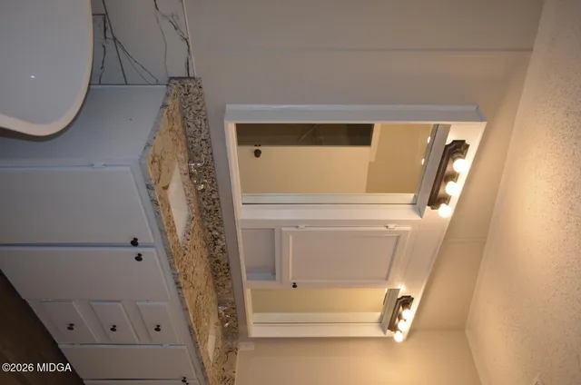 an empty room with windows and fireplace