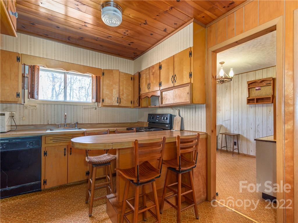 147 Crossroad Hill Road Canton, NC 28716 - Photo 5 of 20 a kitchen with stainless steel appliances granite countertop a table chairs sink and cabinets