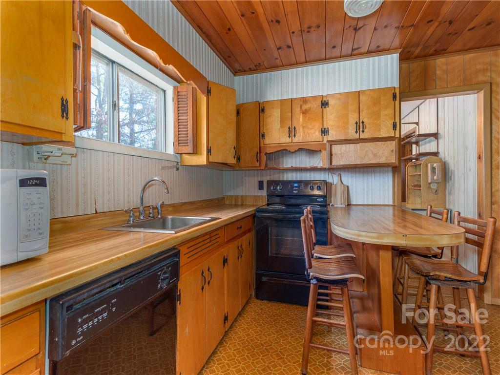 147 Crossroad Hill Road Canton, NC 28716 - Photo 6 of 20 a kitchen with stainless steel appliances granite countertop a sink a stove a table and chairs