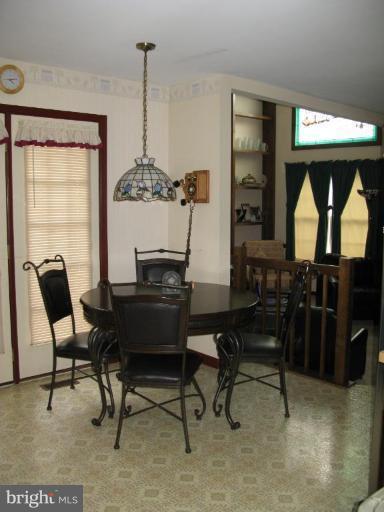 9025 Fieldchat Road Nottingham, MD 21236 - Photo 3 of 11 a view of a dining room with furniture and window