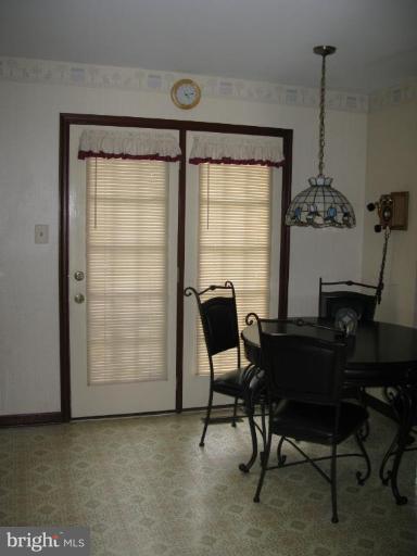 9025 Fieldchat Road Nottingham, MD 21236 - Photo 4 of 11 a view of a workspace with furniture and a window