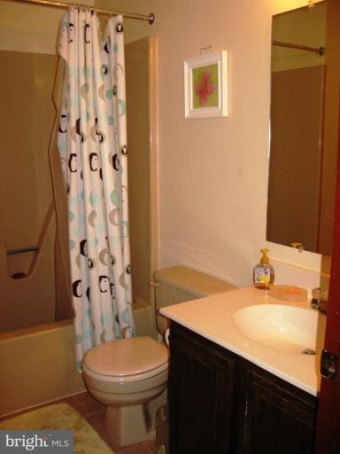 9025 Fieldchat Road Nottingham, MD 21236 - Photo 7 of 11 a bathroom with a sink a toilet and shower