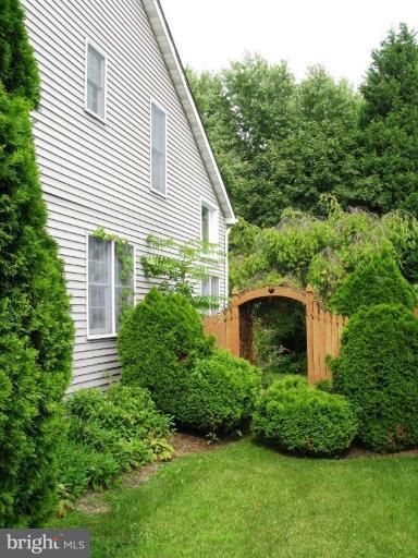 9025 Fieldchat Road Nottingham, MD 21236 - Photo 8 of 11 a view of a house with a yard and plants