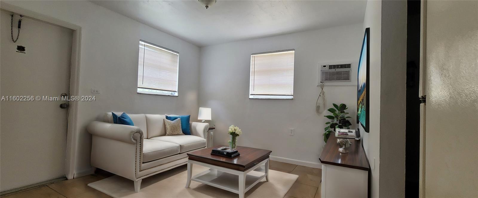 567 Northwest 90th Street, Unit 3 Miami, FL 33150 - Photo 1 of 11 a living room with furniture and a potted plant