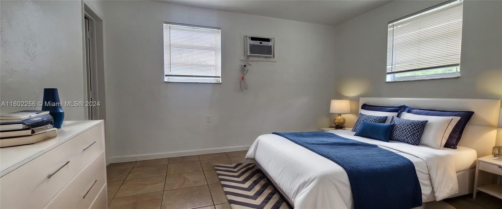 567 Northwest 90th Street, Unit 3 Miami, FL 33150 - Photo 2 of 11 a bedroom with a bed and a cabinets