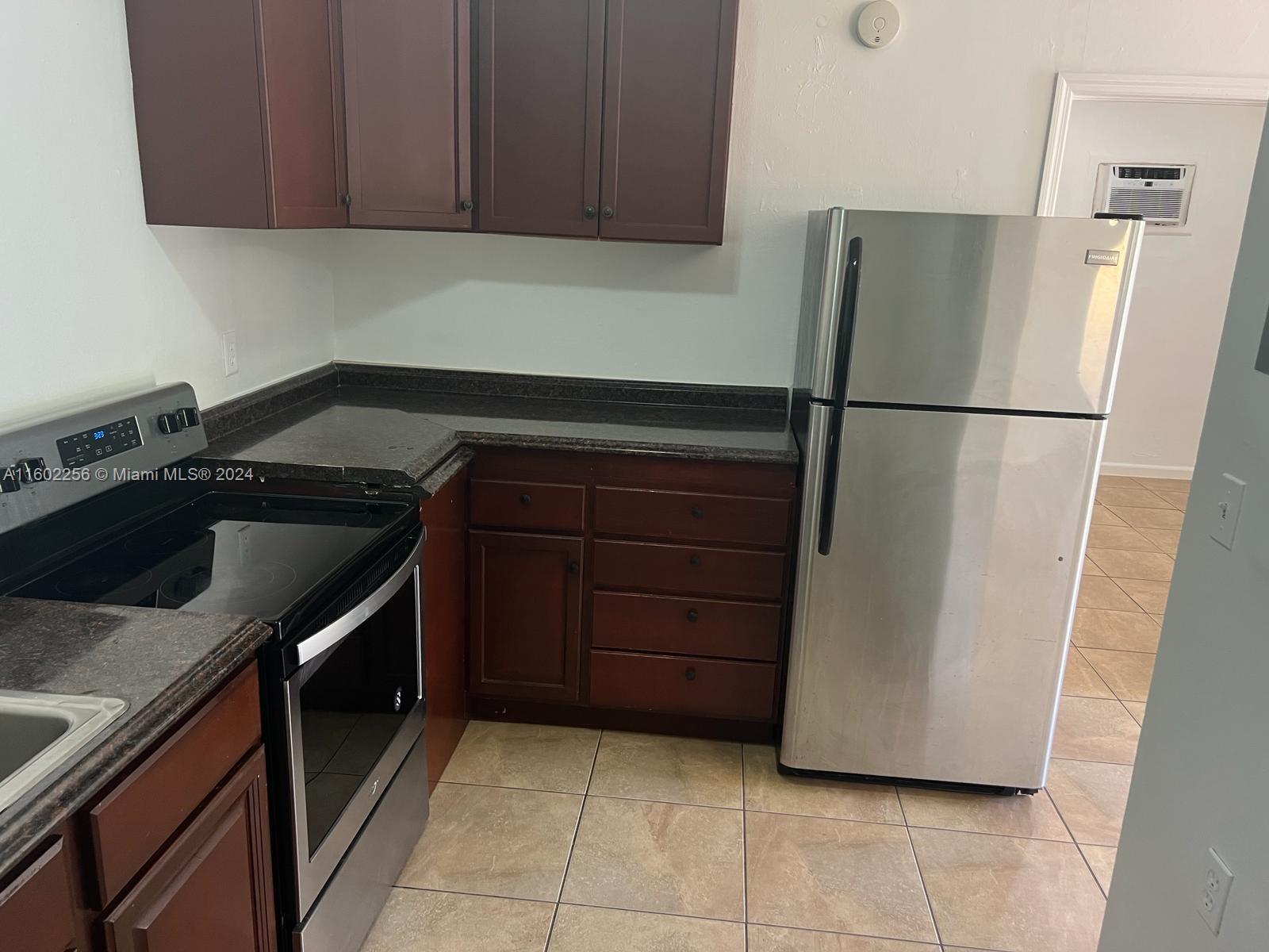 567 Northwest 90th Street, Unit 3 Miami, FL 33150 - Photo 3 of 11 a kitchen with a refrigerator and a sink