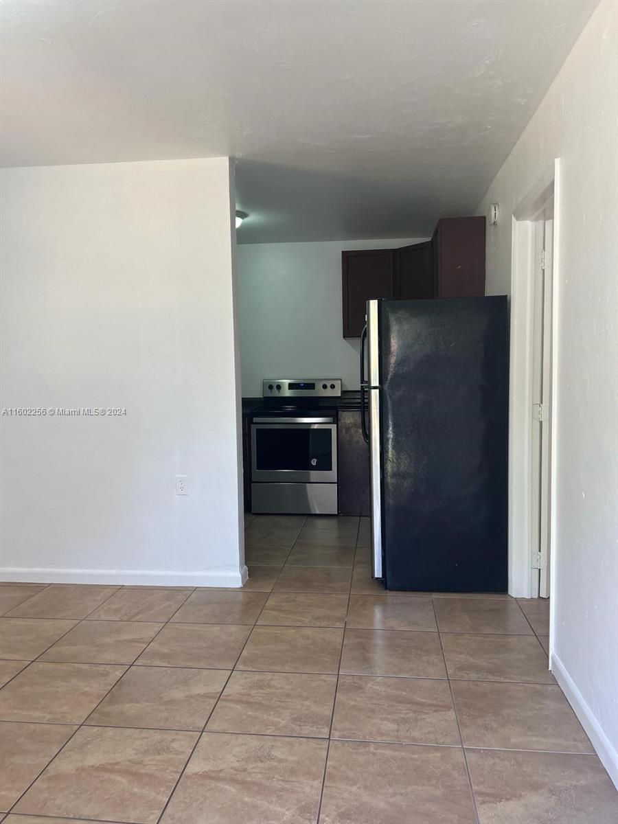 567 Northwest 90th Street, Unit 3 Miami, FL 33150 - Photo 6 of 11 a kitchen with a refrigerator and a sink