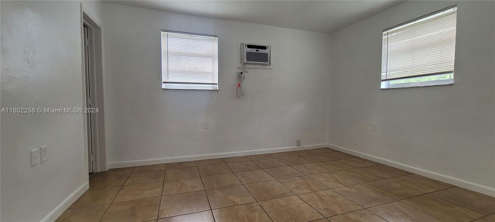 567 Northwest 90th Street, Unit 3 Miami, FL 33150 - Photo 7 of 11 an empty room with windows