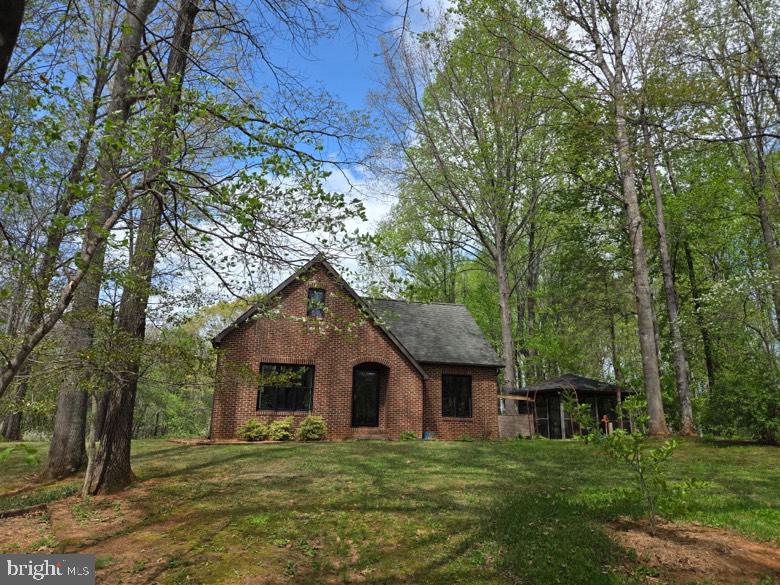 Charming brick home in lush greenery.