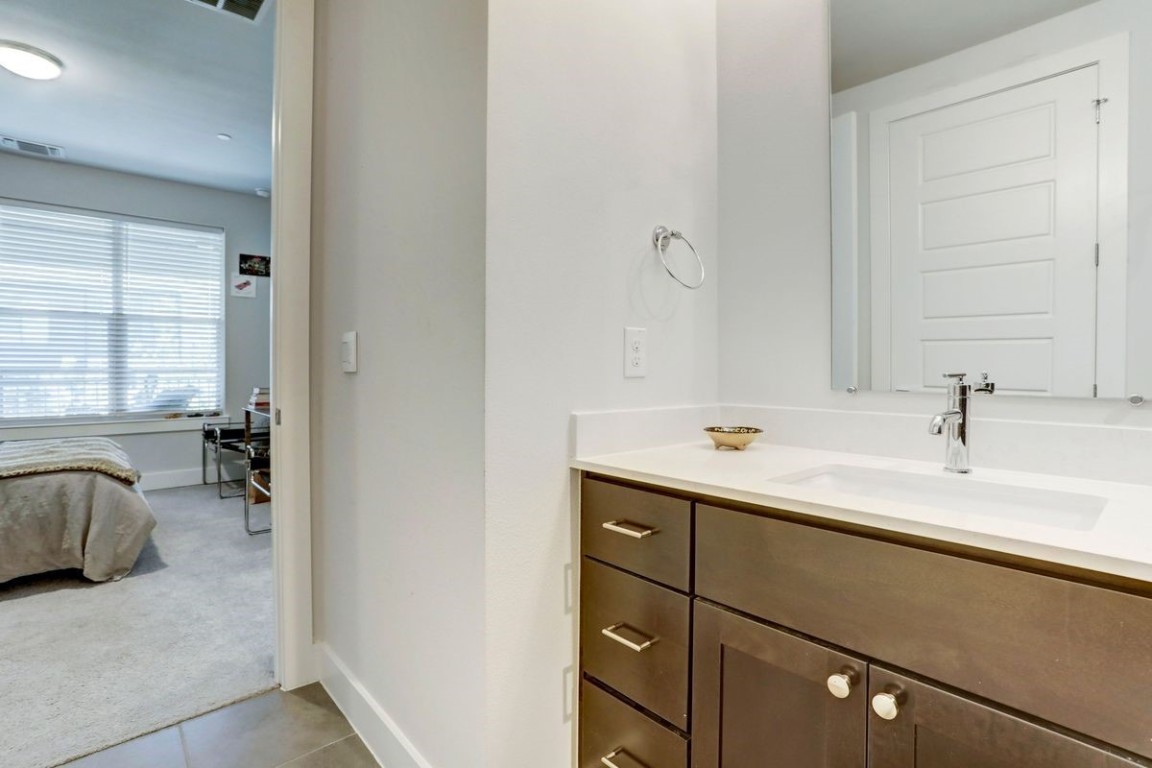 4709 Unity Circle, Unit 273 Austin, TX 78731 - Photo 12 of 14 a bathroom with a sink and a mirror