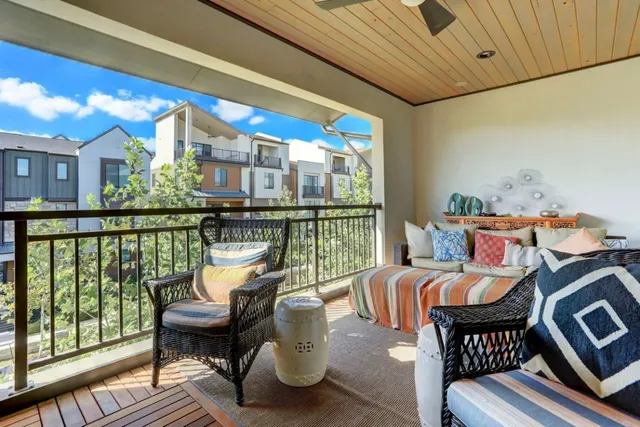 a balcony with furniture and wooden floor