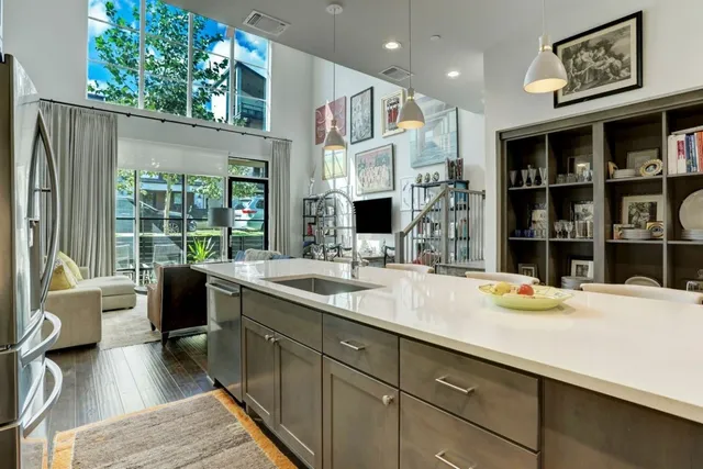 a kitchen with stainless steel appliances granite countertop a sink and wooden cabinets