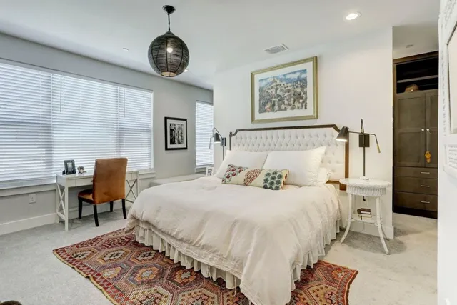 a bedroom with a bed a table and chair