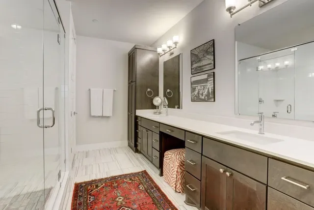 a spacious bathroom with a double vanity sink mirror and double