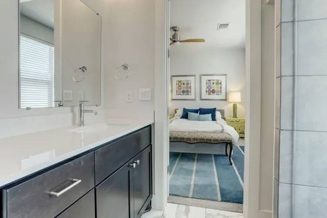 a en suite bathroom with a sink and a window