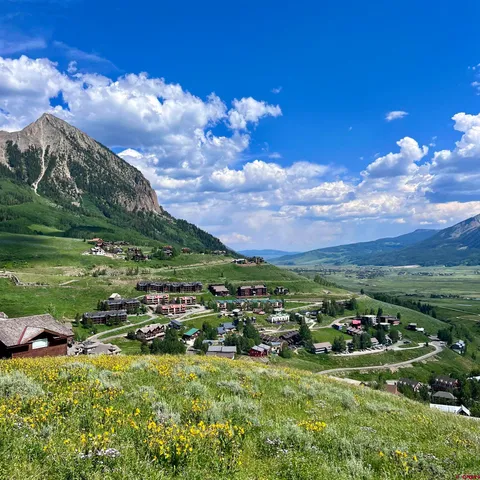 a view of a lake with sunset in background