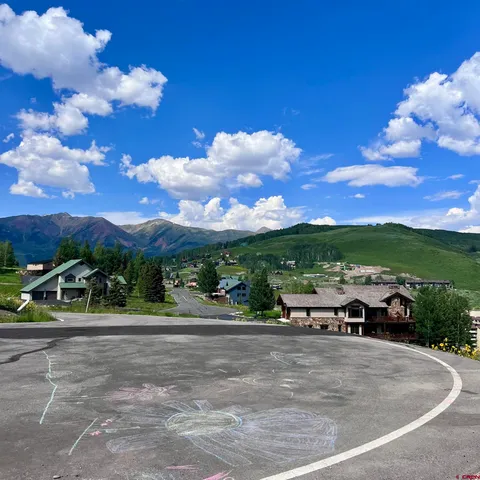 a view of a big yard with lots of green space and mountain view
