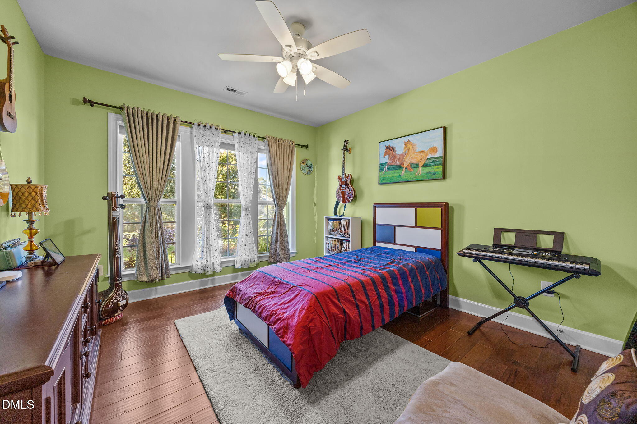 112 Rapport Drive Cary, NC 27519 - Photo 30 of 72 a bedroom with a bed and wooden floor