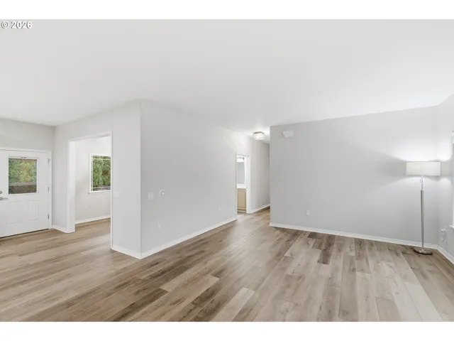 a view of an empty room and wooden floor