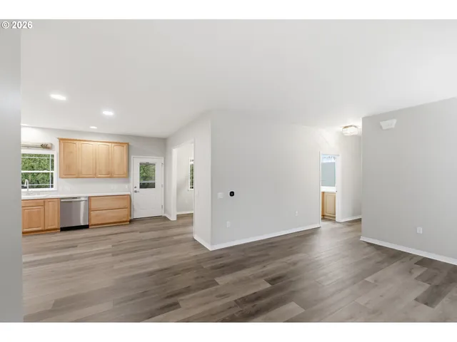 a view of an empty room and wooden floor