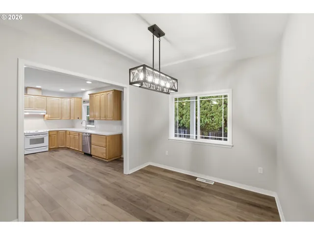 a view of a kitchen with granite countertop wooden floor and a sink