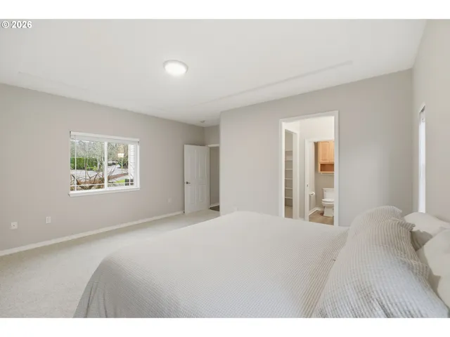 a bedroom with a large bed and a window