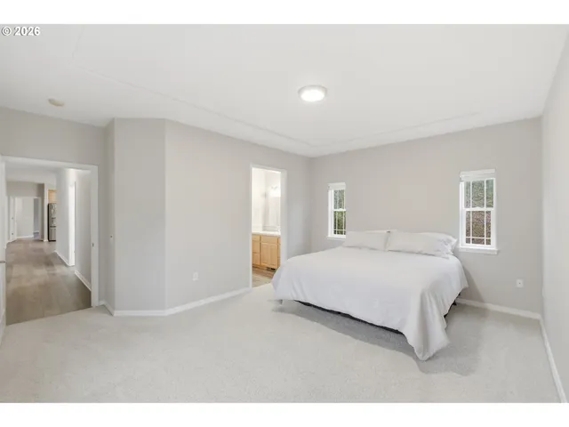 a bedroom with a bed and a night stand