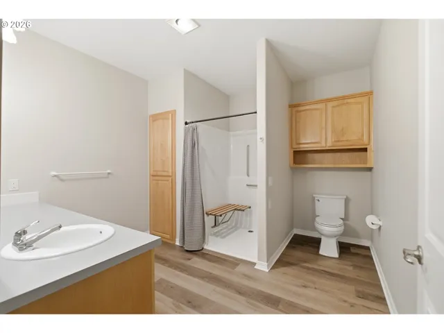 a bathroom with a sink a toilet and a mirror