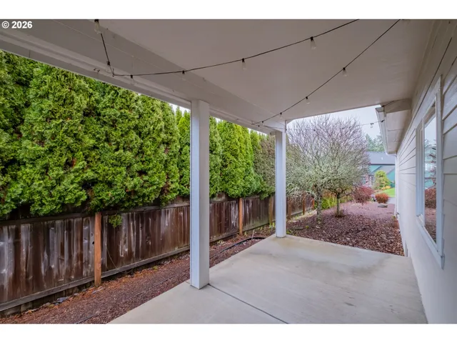 a view of a porch with furniture and garden