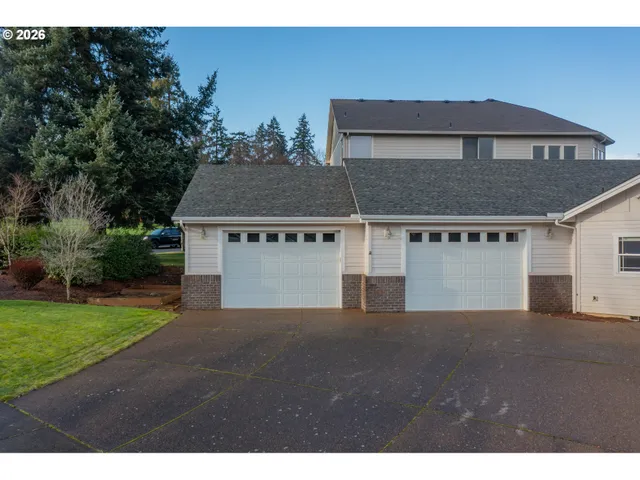 a view of a house with a yard and garage