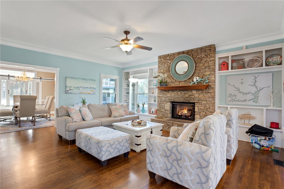 1133 Elrod Ferry Road Hartwell, GA 30643 - Photo 9 of 46 This inviting living room features a beautiful fireplace, perfect for cozy gatherings and comfortable living.