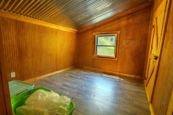 2167 Powdermill Hill Road Lawrenceburg, TN 38464 - Photo 15 of 33 an empty room with wooden floor and windows