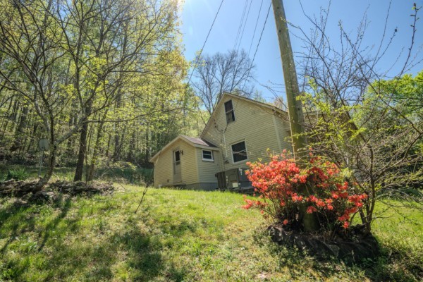 2167 Powdermill Hill Road Lawrenceburg, TN 38464 - Photo 20 of 33 a house is sitting in middle of the green field