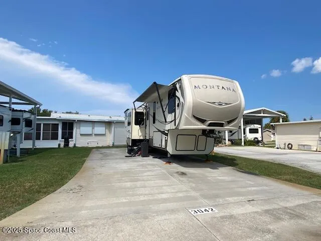 a view of a house with backyard space and sitting area