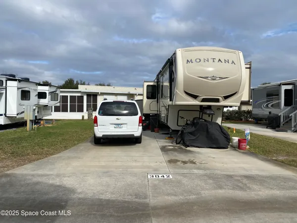 a view of a car parked in the yard