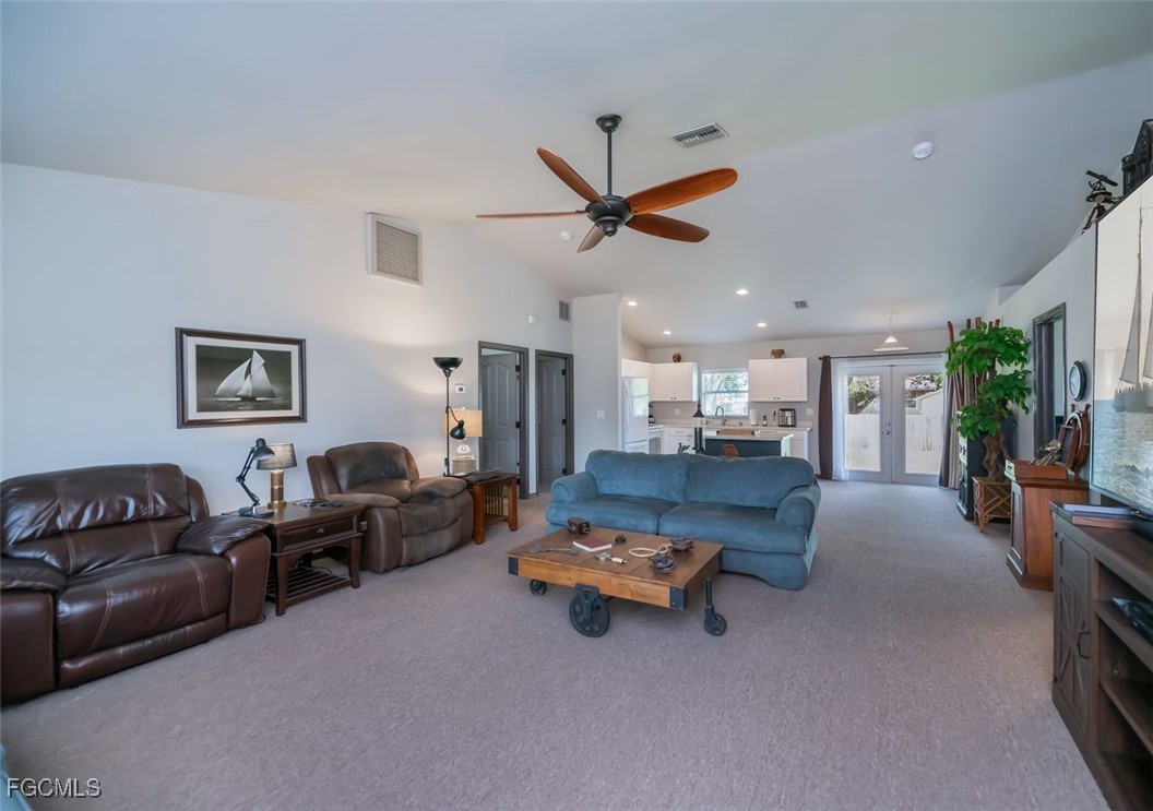 4108 13th Street Southwest Lehigh Acres, FL 33976 - Photo 12 of 48 a living room with furniture and kitchen view