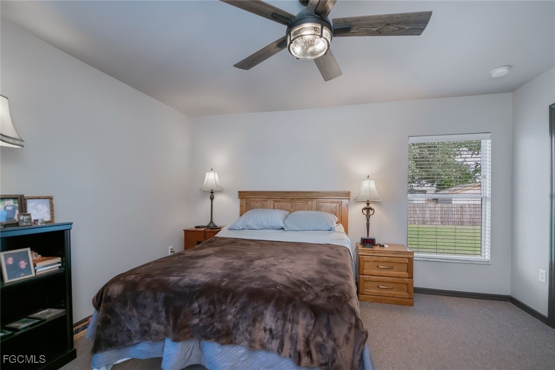 4108 13th Street Southwest Lehigh Acres, FL 33976 - Photo 18 of 48 a bedroom with a bed dresser and a window