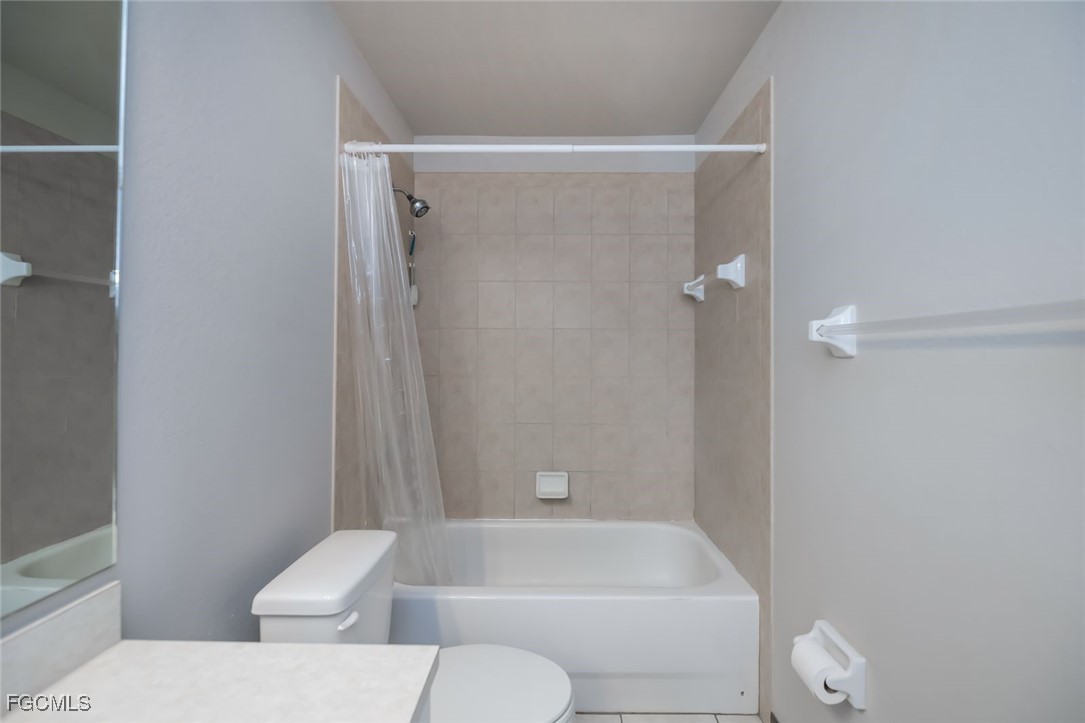 4108 13th Street Southwest Lehigh Acres, FL 33976 - Photo 19 of 48 a bathroom with a toilet and a shower